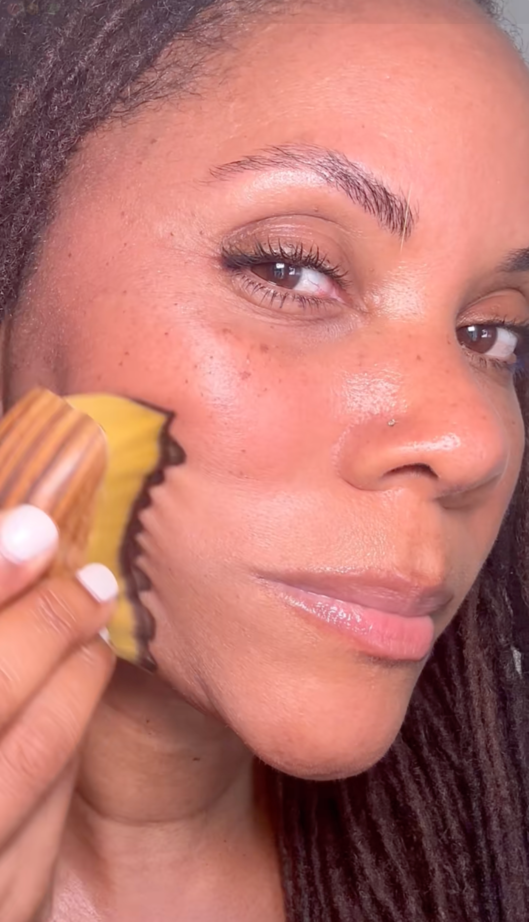 Customer using the Kojeva lymphatic face brush